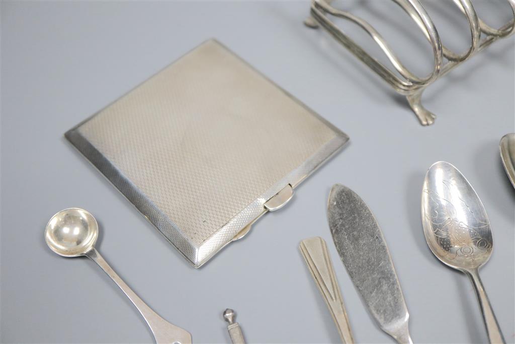 An early 20th century silver toastrack, a silver bowl, silver cigarette case and minor flatware including silver and plated.